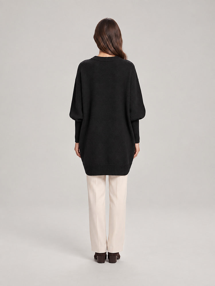 Women's chunky knit poncho jumper with an asymmetric hem