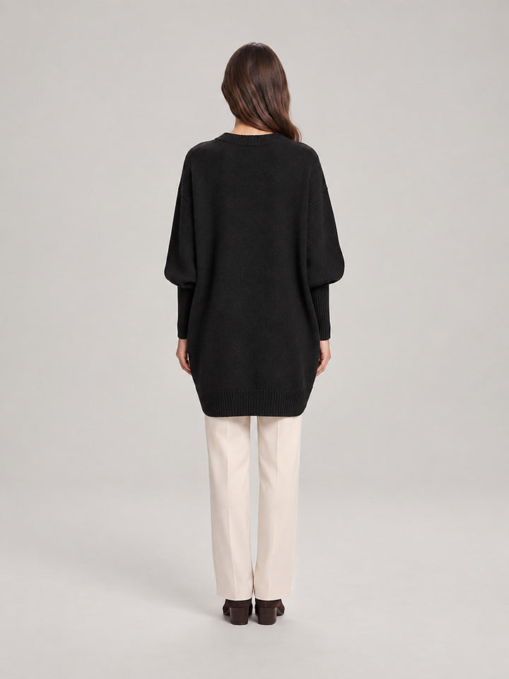 Women's chunky knit poncho jumper with an asymmetric hem