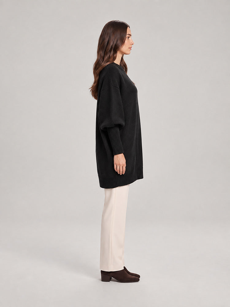 Women's chunky knit poncho jumper with an asymmetric hem