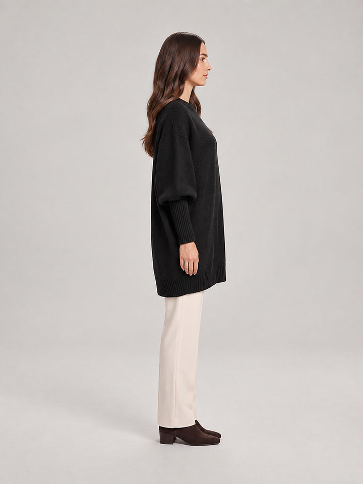 Women's chunky knit poncho jumper with an asymmetric hem