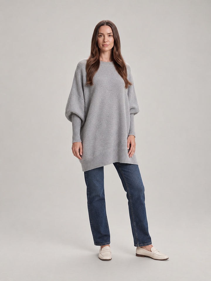 Women's chunky knit poncho jumper with an asymmetric hem in light grey
