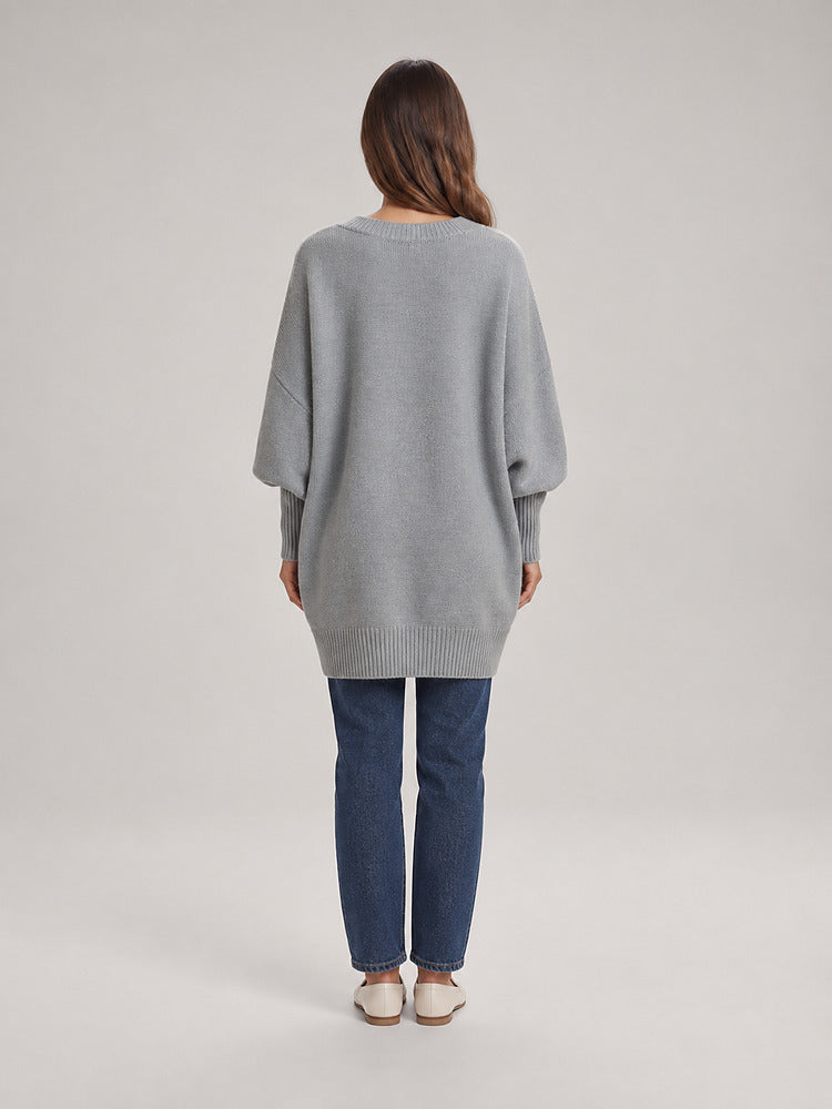 Women's chunky knit poncho jumper with an asymmetric hem