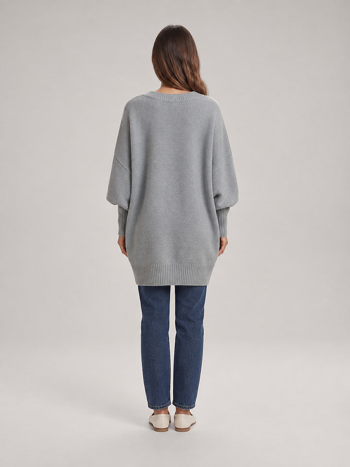Women's chunky knit poncho jumper with an asymmetric hem