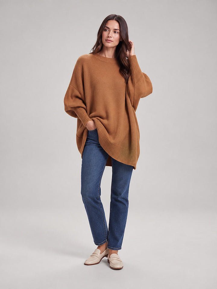 Women's chunky knit poncho jumper with an asymmetric hem in brown