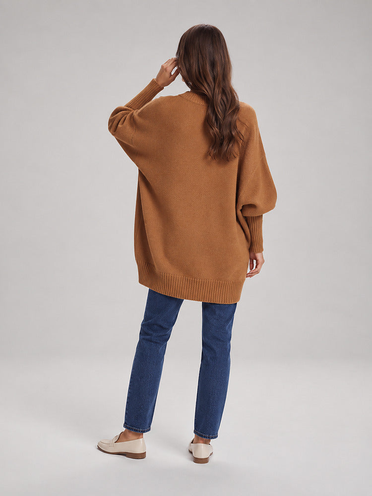 Women's chunky knit poncho jumper with an asymmetric hem