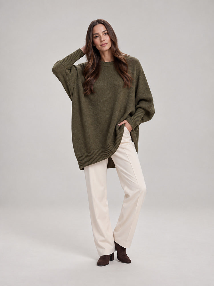 Women's chunky knit poncho jumper with an asymmetric hem in emerald green