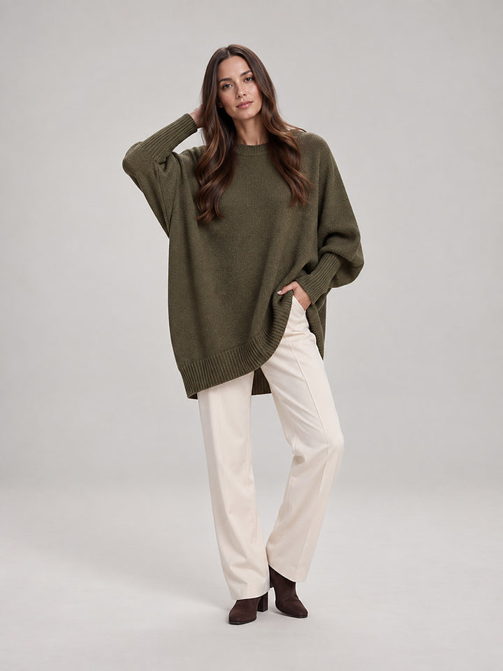 Women's chunky knit poncho jumper with an asymmetric hem in emerald green