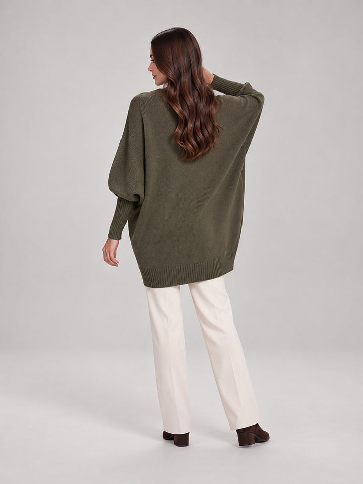 Women's chunky knit poncho jumper with an asymmetric hem