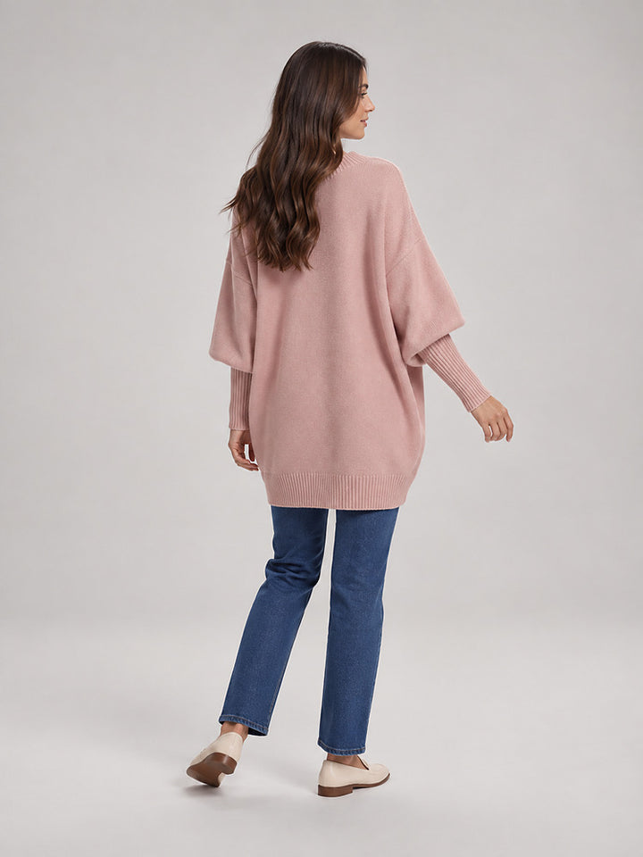 Women's chunky knit poncho jumper with an asymmetric hem