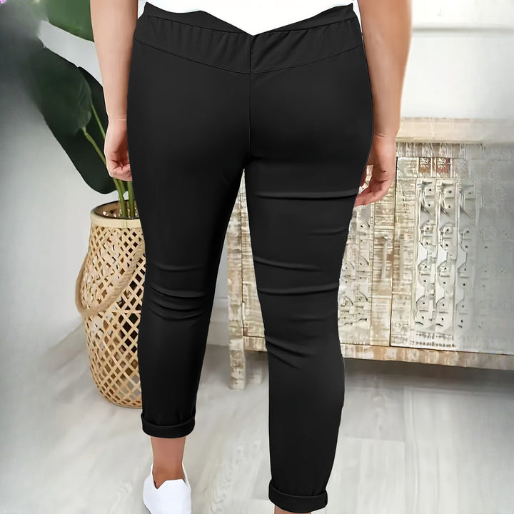 Women's drawstring tapered trousers in black, back view
