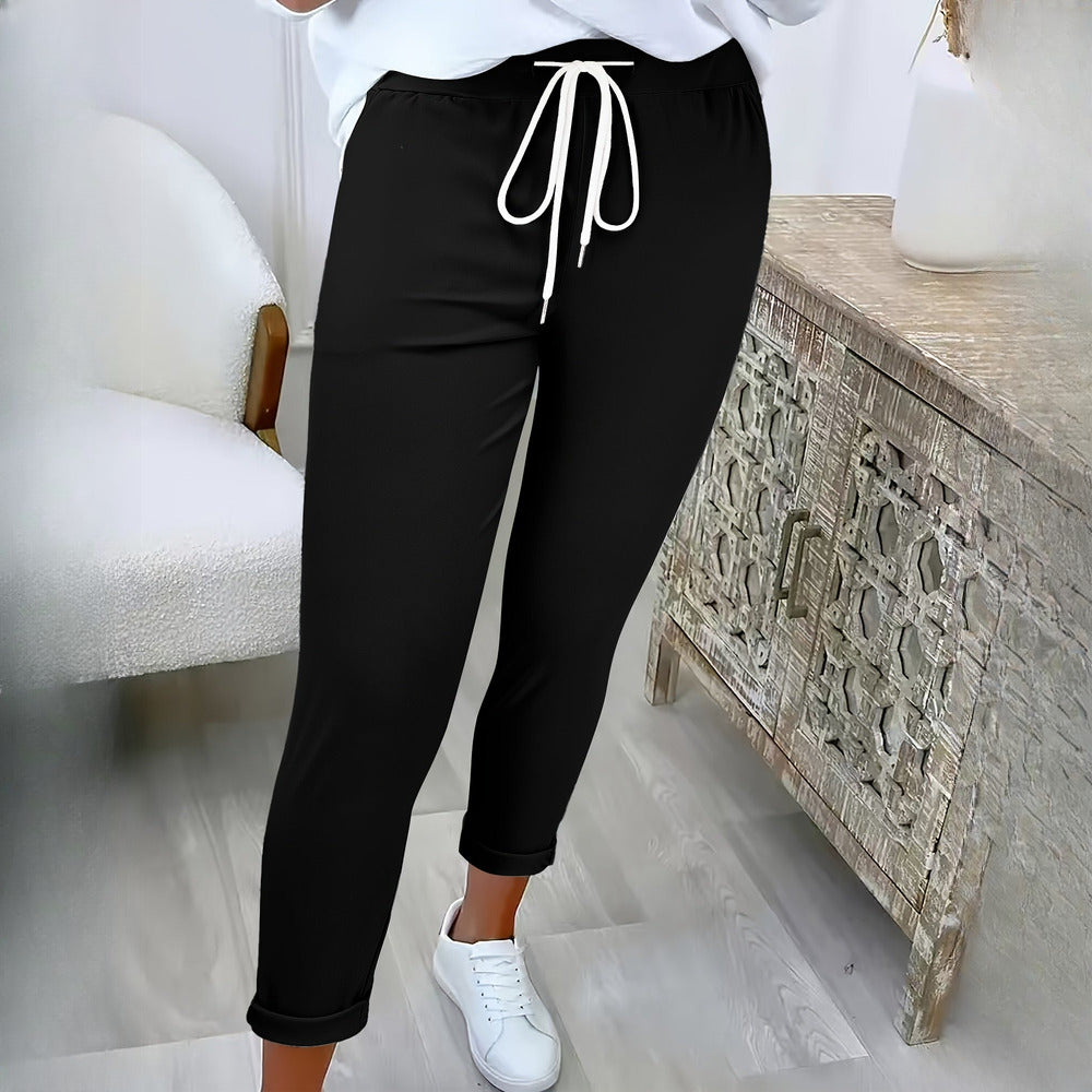 Women's drawstring tapered trousers in black, worn on model