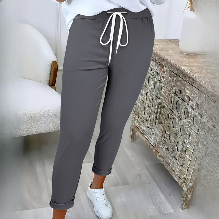 Women's drawstring tapered trousers in dark grey, worn on model