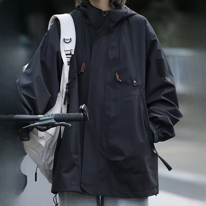 Women's windproof hooded mountain jacket in black, worn on model