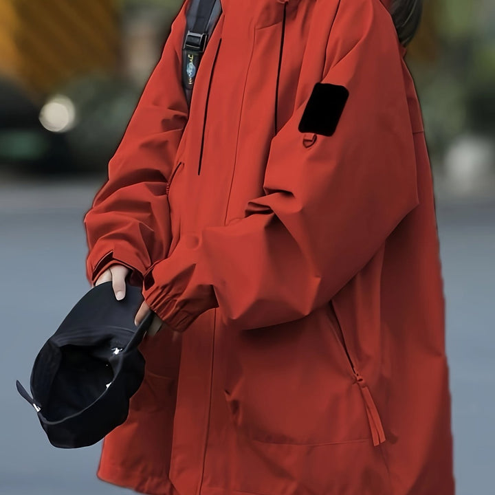 Women's windproof hooded mountain jacket in brick red