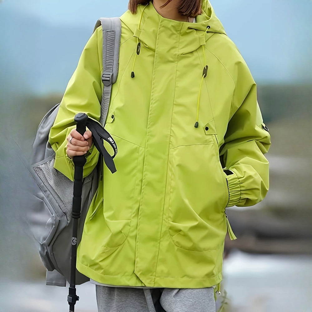 Women's windproof hooded mountain jacket in lime green, worn on model