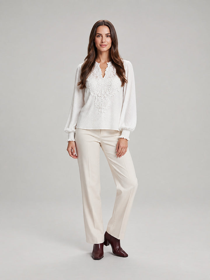 Women's blouse with an openwork front panel and long sleeves in white