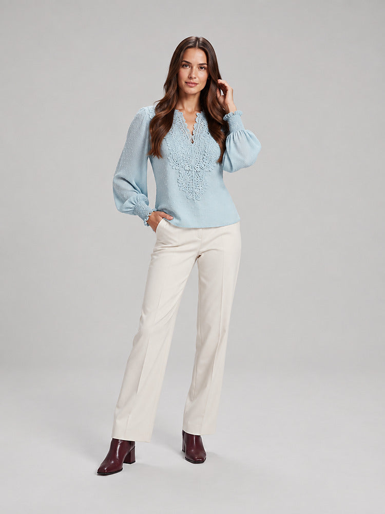 Women's blouse with an openwork front panel and long sleeves in light blue