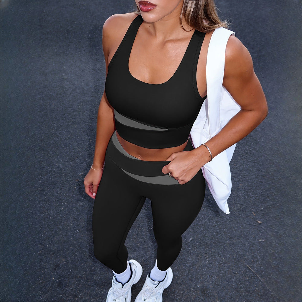 Women's two-piece activewear set in black, worn on model