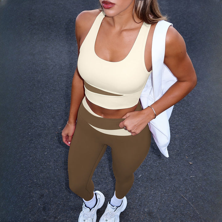 Women's two-piece activewear set in cream and brown, worn on model